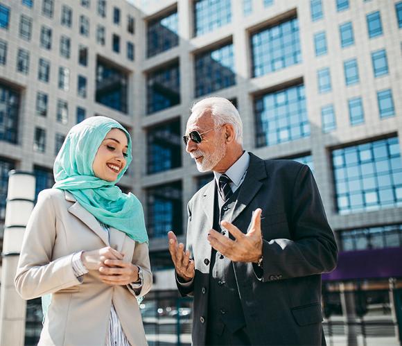 Business woman and Business man Talking in front of a building in the UAE 